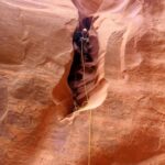 Stepping onto the awkward rappel.